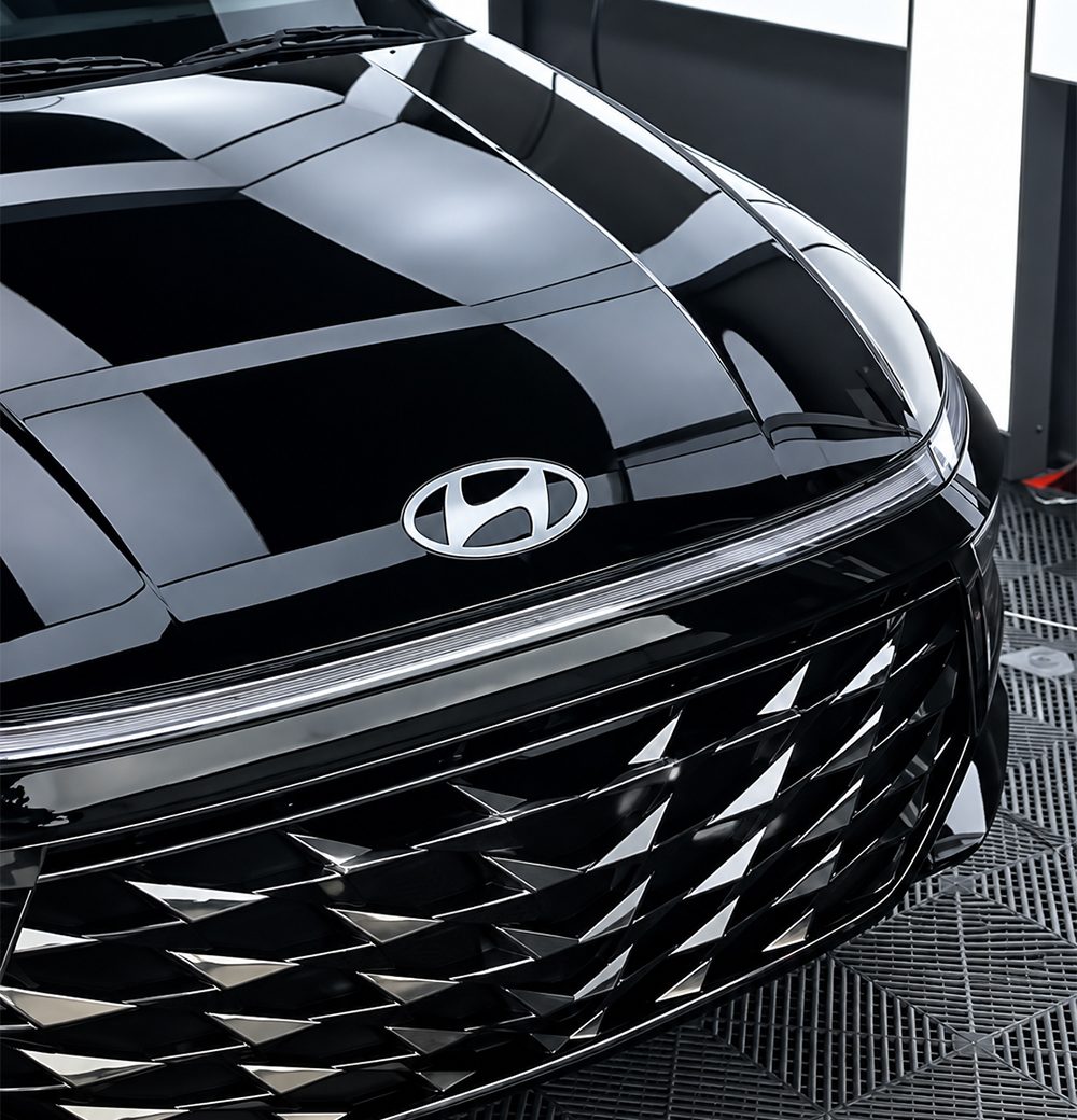 Deep gloss on the bonnet and grille of a black car
