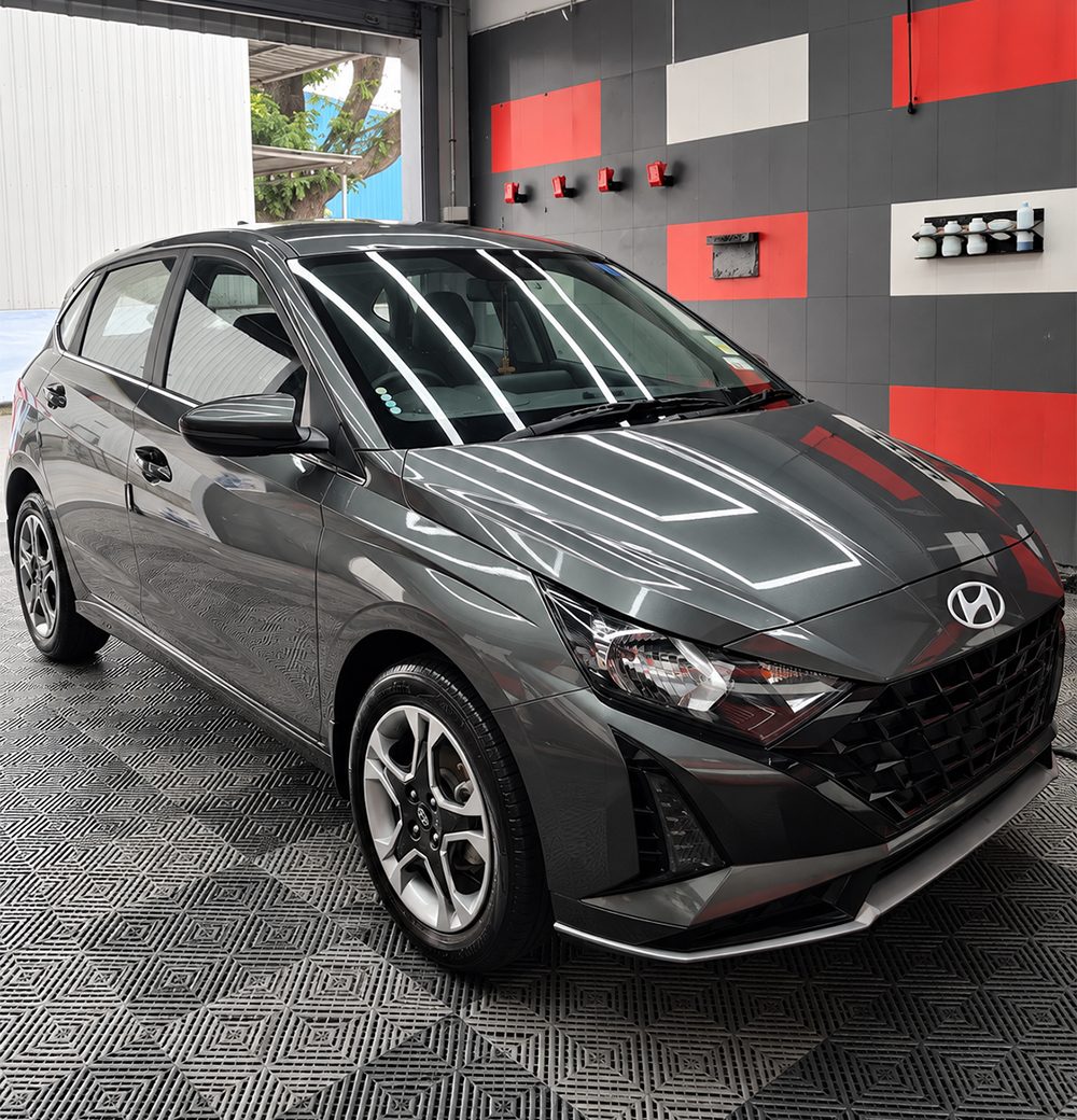 Grey hatchback with a glossy finish inside The Detailing Mafia Poonamallee workshop