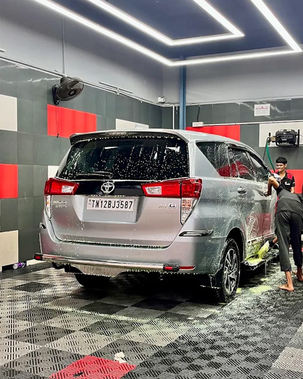 Technicians foam washing a car inside The Detailing Mafia Poonamallee workshop